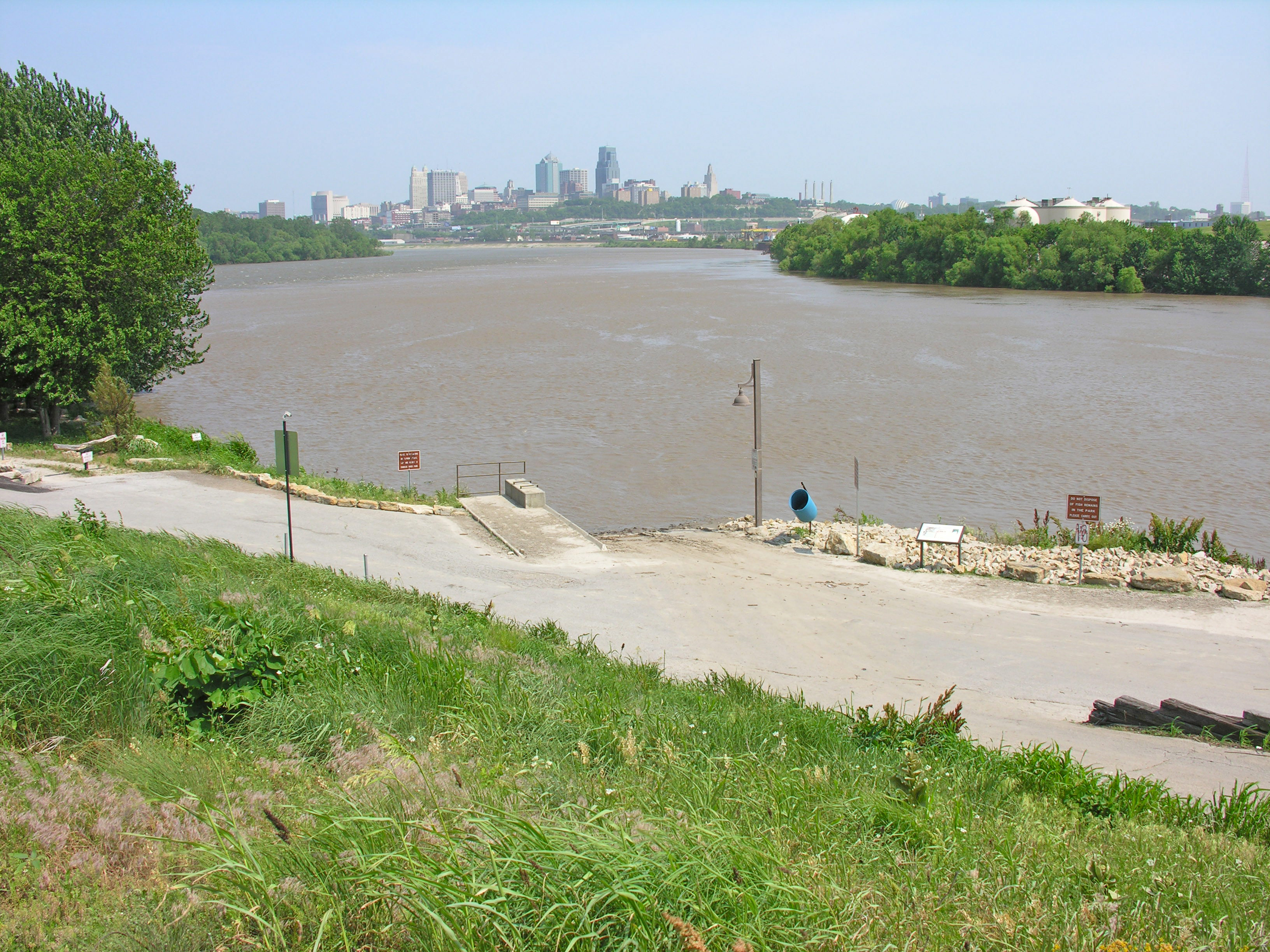 Kaw Point Park, Missouri River bend and confluence with Kansas River (left behind tree), and Kansas City, Missouri, skyline.