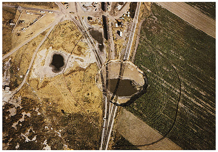 Tracks suspended over Cargill sinkhole, Reno County, 1974 (Denning Studios).