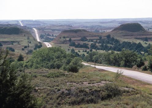 Highway running through hilly countryside