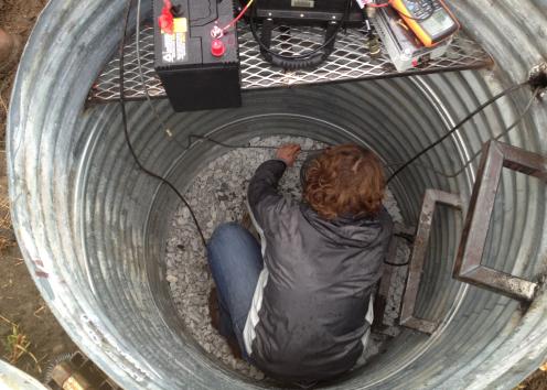 A KGS scientist installs an earthquake monitor in Sumner County.