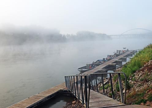 Dock and boats on foggy river