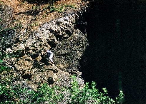 Man climbing out of sinkhole