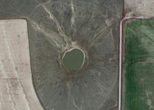 Aerial view of water-filled sinkhole