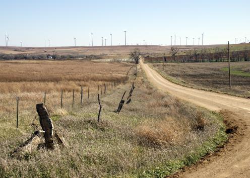 Limestone fence posts with windfarm in background