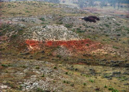 Red rocks under light-colored Ogallala Formation