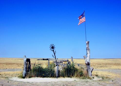 A sunflower sculpture and U.S. flag mark the highest point in Kansas